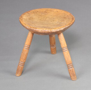 An 18/19th Century circular turned hardwood stool, raised on 3 ring turned supports 31cm h x 30cm diam. 