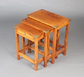 A nest of 3 rectangular Indian hardwood and brass mounted military style coffee tables, raised on square supports 52cm h x 47cm w x 30cm d, the smallest fitted a drawer 