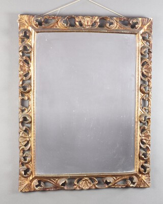 A 19/20th Century rectangular plate mirror contained in a carved gilt wood and plaster pierced frame 72cm h x 55cm w 