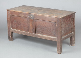 An 18th Century oak coffer of panelled construction with hinged lid 59cm h x 112cm w x 46cm d 