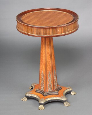 An Empire circular kingwood and gilt mounted pedestal table, raised on a chamfered column with shaped base, brass paw feet 73cm h x 51cm diam. 