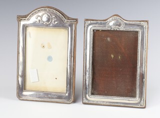 A repousse silver photograph frame Birmingham 1918 20cm, a ditto Chester 1915 19cm 