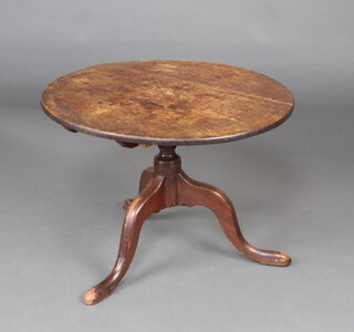 An 18/19th Century circular snap top tea table, raised on a turned column and tripod base 52cm h x 70cm diam. 