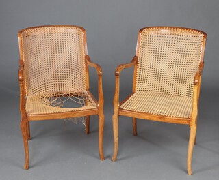 A pair of 1940's beech framed open armchairs with cane seats and backs, raised on cabriole supports 84cm h x 52cm w x 42cm d 