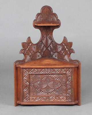 A Victorian carved mahogany hanging corner cabinet, fitted a shelf and niche above cupboard enclosed by a panelled door 56cm h x 38cm w x 27cm d 