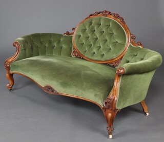 A Victorian carved walnut show frame sofa, upholstered in green buttoned material, raised on cabriole supports 91cm h x 173cm w x 70cm d (seat 120cm x 46cm) 