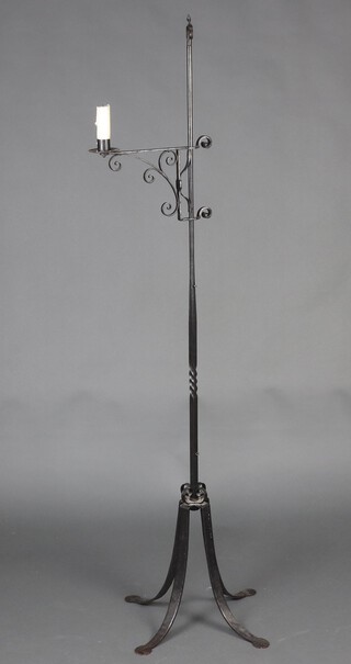 A wrought iron candle stand 167cm x 36cm 