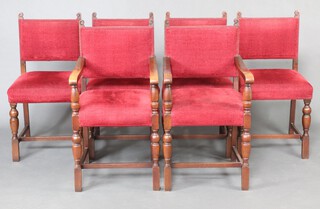 A set of 6 oak framed dining chairs - 2 carvers, 4 standard, the seats and backs upholstered in red material 