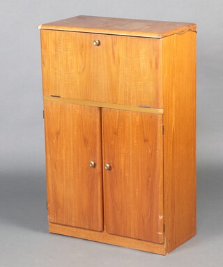 A mid-century teak cocktail cabinet with hinged lid and mirrored interior, the base enclosed by a panelled door 97cm h x 62cm w x 34cm d (scratches, water and contact marks in places) 