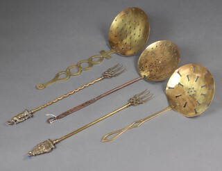 Three 19th Century brass cream skimmers and 2 brass toasting forks 