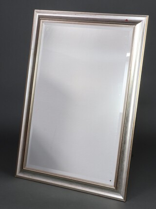 A rectangular bevelled plate mirror contained in a silver coloured frame 174cm x 106cm 