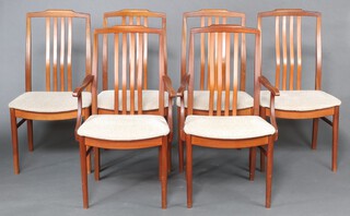 A mid-century style set of 6 teak stick and rail back dining chairs - 2 carvers, 4 standard with over stuffed seats on square tapered supports 95cm h x 52cm w x 44cm d 