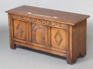 A 17th Century style rectangular carved oak coffer with hinged lid 53cm h x 104cm w x 39cm d (water and contact marks in places) 