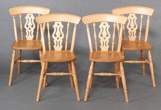 A set of 4 beech and elm Windsor style bar back dining chairs with solid seats, raised on turned supports with H framed stretchers 85cm h x 35cm w x 34cm d 