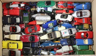 A quantity of model cars, all unboxed, contained in a cardboard box 