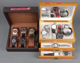 Twenty gentleman's fashion wristwatches, contained in display cases (sold as seen and may require new batteries)