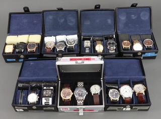 Twenty gentleman's fashion wristwatches, contained in display cases (sold as seen and may require new batteries)