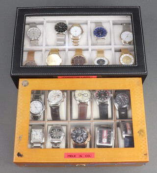 Twenty gentleman's fashion wristwatches, contained in display cases (sold as seen and may require new batteries)