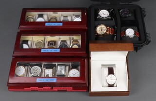 Twenty gentleman's fashion wristwatches, contained in display cases (sold as seen and may require new batteries)