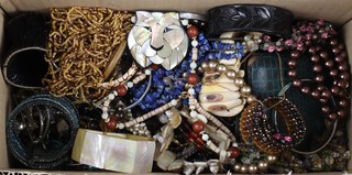 A quantity of vintage costume jewellery including bangles, bead necklaces, brooches, etc 