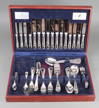 A mahogany finished canteen of beaded steel cutlery 