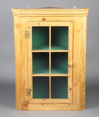 A 19th Century style pine corner cabinet enclosed by astragal glazed panelled doors 93cm h x 66cm w x 46cm d 