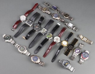 Twenty gentleman's fashion wristwatches, contained in display cases (sold as seen and may require new batteries)