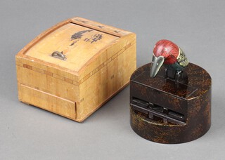 A novelty plastic cigarette dispenser and a wooden Japanese ditto