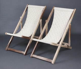 A pair of bleached hardwood folding deck chairs with macrame style seats 95cm  