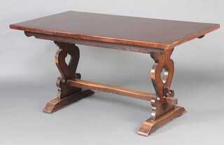 An oak refectory style dining table raised on standard end supports with H framed stretcher 75cm h x 154cm l x 79cm w 