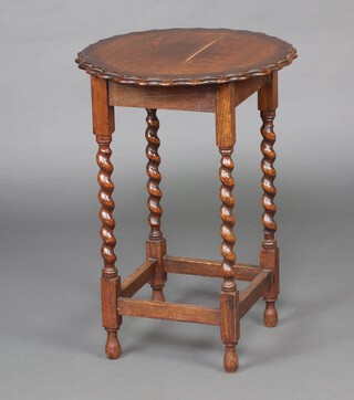 A 1930's circular oak occasional table with pie crust edge on spiral turned supports 70cm h x 49cm diam. 