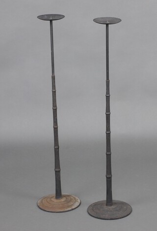 A pair of iron pricket candle sticks 94cm h