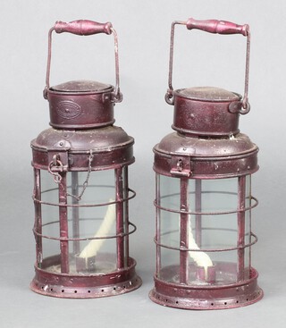 Two cylindrical metal hand lanterns