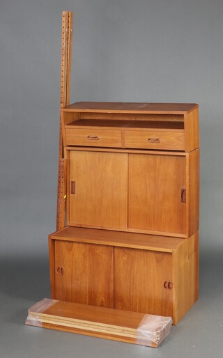 A quantity of Ladderax shelving comprising two cabinets and a unit with a recess above two long drawers 