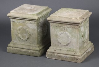 A pair of concrete well weathered pedestals