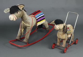 A large Merrythought rocking donkey 65cm x 108cm x 35cm and a push-along donkey 62cm x 54cm x 25cm 