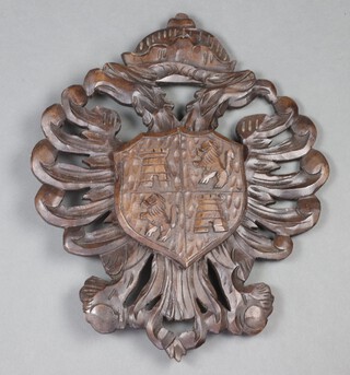 A Germanic style carved wooden armorial wall panel depicting the Toledo coat of arms