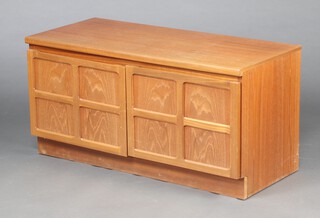 A Nathan mid-century teak cabinet enclosed by panelled doors 51cm h x 102cm w x 45cm d 