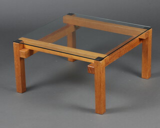 A mid-century square teak and plate glass lamp table, raised on square supports 33cm h x 61cm 