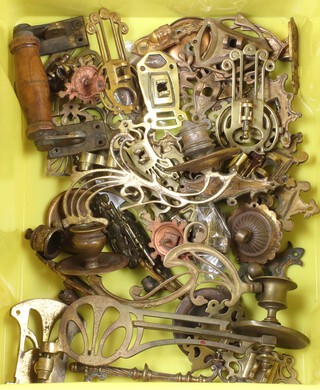 A collection of gilt metal piano sconces contained in a yellow plastic box