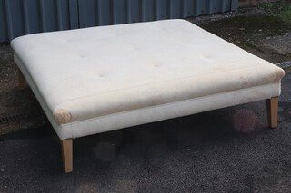 A large square beech framed country house stool/day bed, upholstered in white buttoned material 45cm h x 156cm (some stains in places)