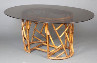 An oval bamboo dining table with plate glass top 71cm h x 171cm w x 109cm d 