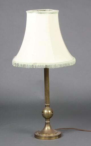 A reeded gilt metal table lamp raised on a circular base 52cm h 