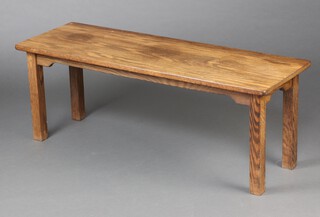 A rectangular oak coffee table, raised on square supports 45cm h x 123cm w x 40cm d 