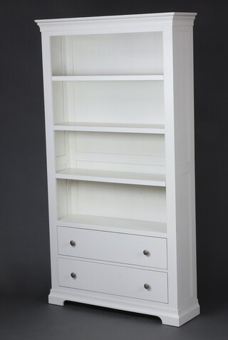 A white painted bookcase with moulded cornice, the base fitted 2 drawers, raised on bracket feet 196cm h x 105cm w x 30cm d 