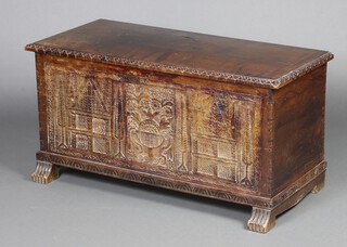 An 18/19th Century Continental carved camphor coffer with hinged lid, the front panel extensively carved with trees and buildings 57cm h x 109cm w x 48cm d 