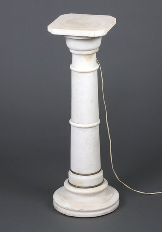 A turned white marble pedestal, the interior fitted a light bulb, raised on a turned support 74cm h x 25cm 