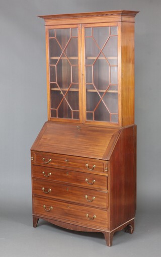 An Edwardian mahogany matched bureau bookcase with moulded and dentil cornice, fitted shelves enclosed by astragal glazed panelled doors, the fall front revealing a fitted interior above 4 long drawers 214cm h x 91cm w x 51cm d  