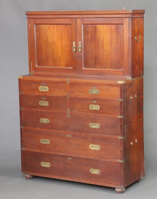 Smee & Cobay Manufacturers, 29,30,31,33,36, 37 and 39 Moorfield London EC, a 19th Century camphor and brass banded military chest), the associated upper section fitted a cupboard enclosed by a pair of panelled doors, the 2 section base fitted 4 short and 3 long drawers, raised on bun feet 176cm h x 119cm w x 50cm d 