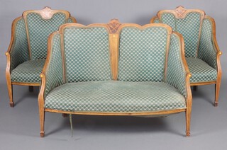 An Edwardian inlaid mahogany drawing room suite upholstered in green and white material raised on square tapered supports, spade feet, comprising a 2 seat sofa 92cm h x 124cm w x 50cm d (seat 96cm x 40cm) and 2 matching armchairs 91cm h x 64cm w x 53cm d, inlaid torches in saltire